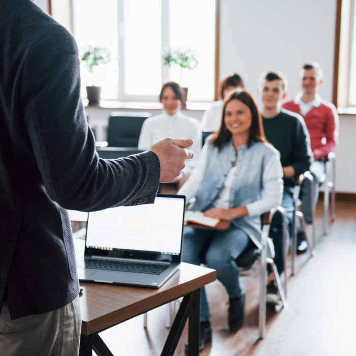 Cheerful mood. Group of people at business conference in modern classroom at daytime.